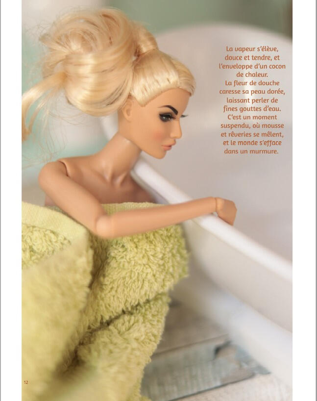 Photograph from the photo book Little Moments showing a Rayna Ahmadi blonde doll sitting beside a bathtub, wrapped in a bath towel in a calm, intimate bathroom scene