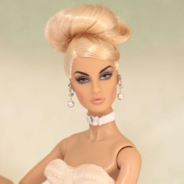 Picture of a blonde doll named Rayna Ahmadi wearing a hairdo